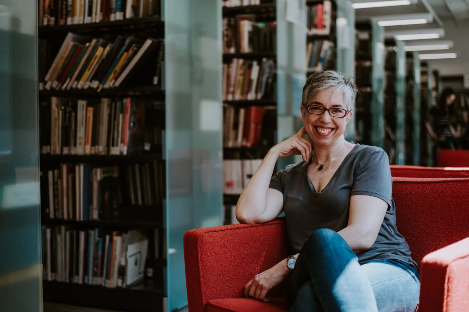 Creator full portrait in library Jessica Abel