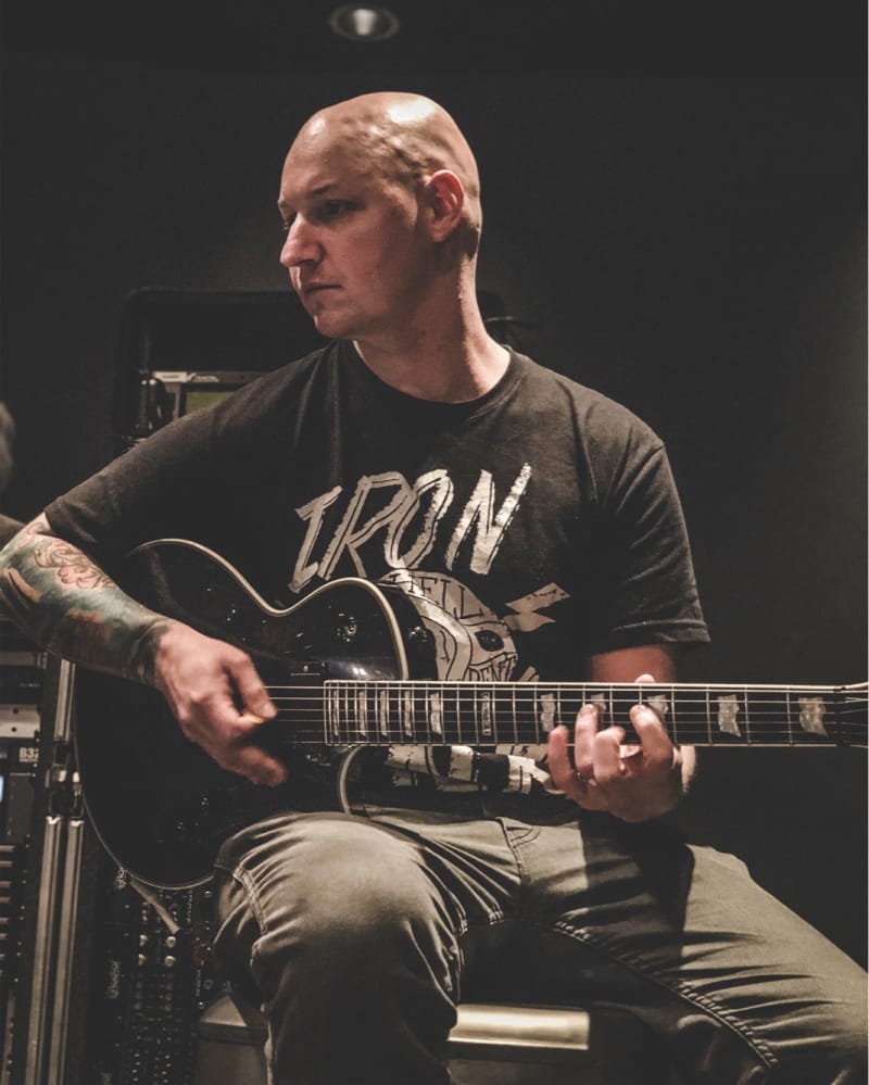 iaac-ryan-baustert-in-studio-playing-guitar