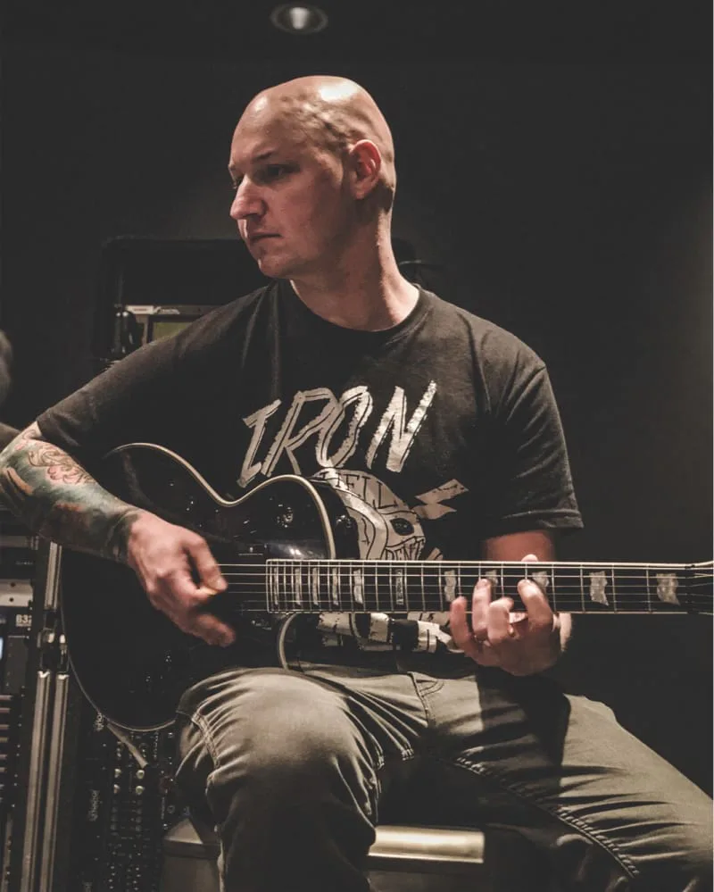 iaac-ryan-baustert-in-studio-playing-guitar