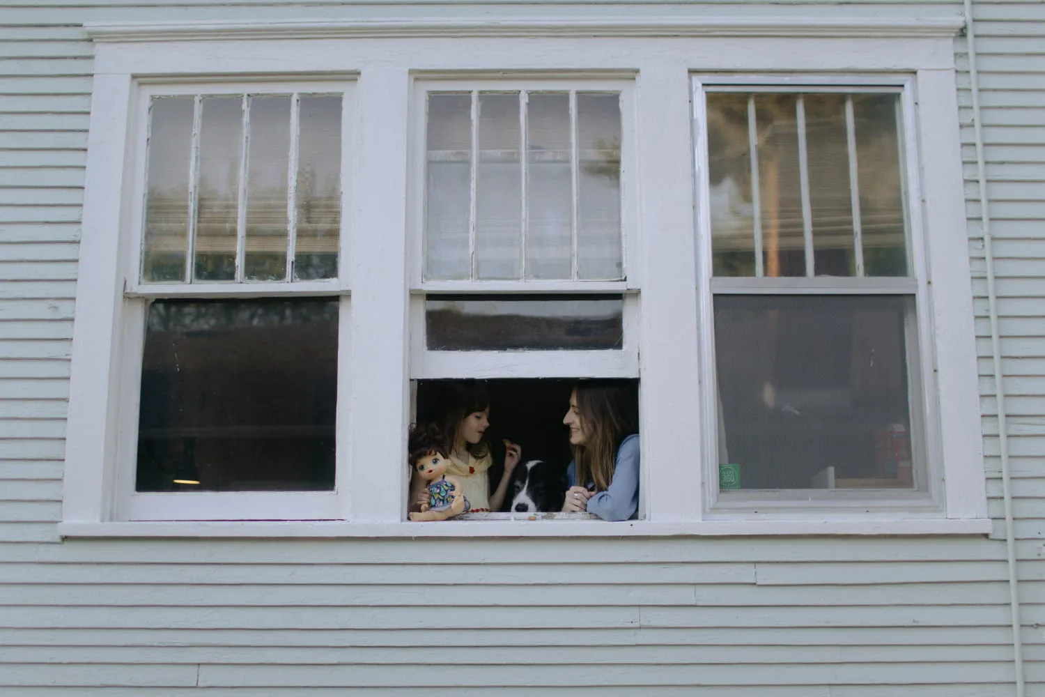 iaac-kelsey-baldwin-and-daughter-sitting-in-front-of-window