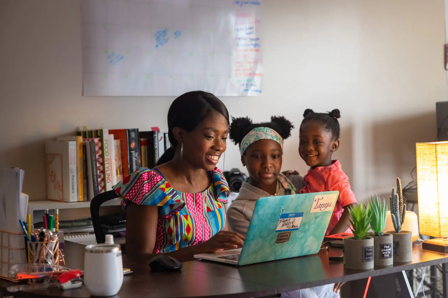 iaac-tanya-harris-on-laptop-with-kids