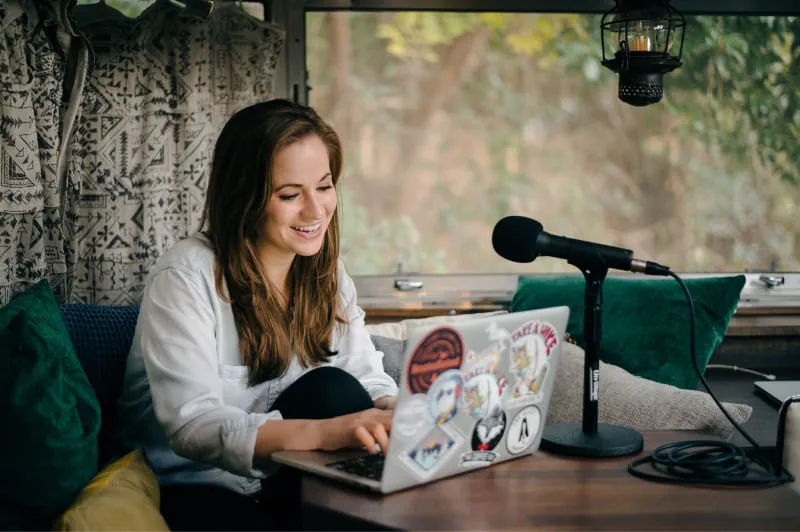 iaac-nick-true-hannah-recording-podcast-and-typing-on-laptop-in-airstream