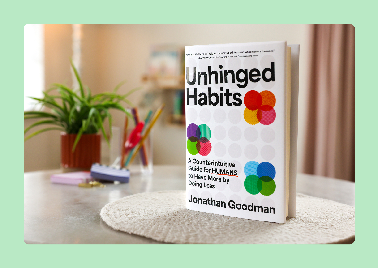 Unhinged Habit book sitting on a table with a green border