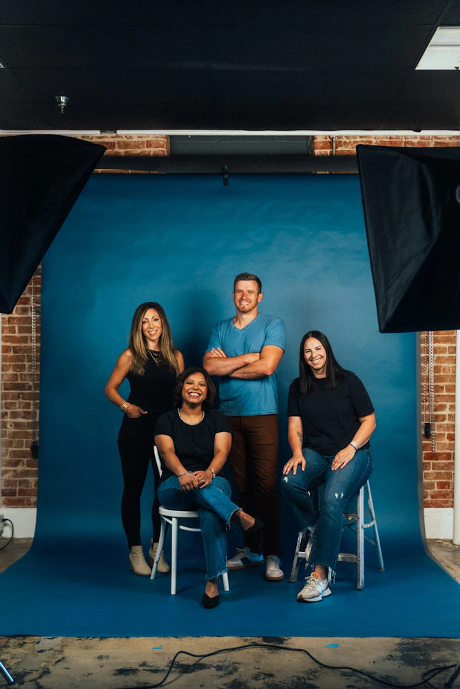 A group of creators sitting and standing together