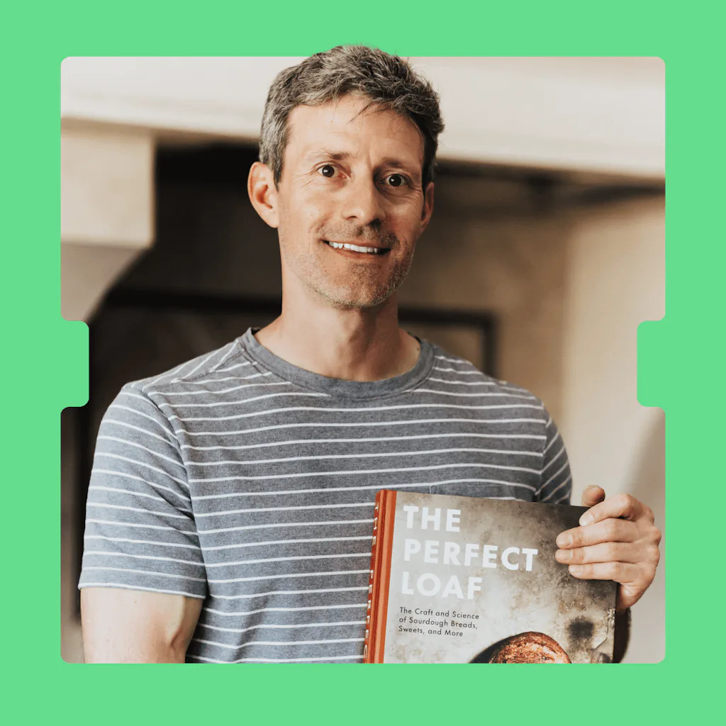 headshot of Maurizio Leo holding his book on a green background