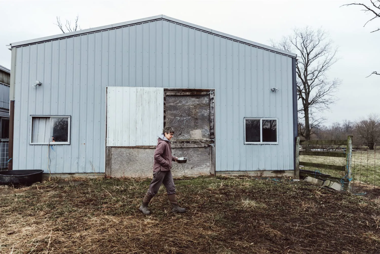 Deborah walking across barn
