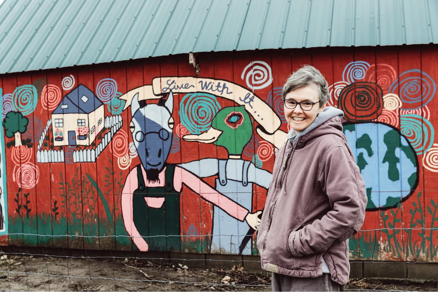 Her in front of goat barn