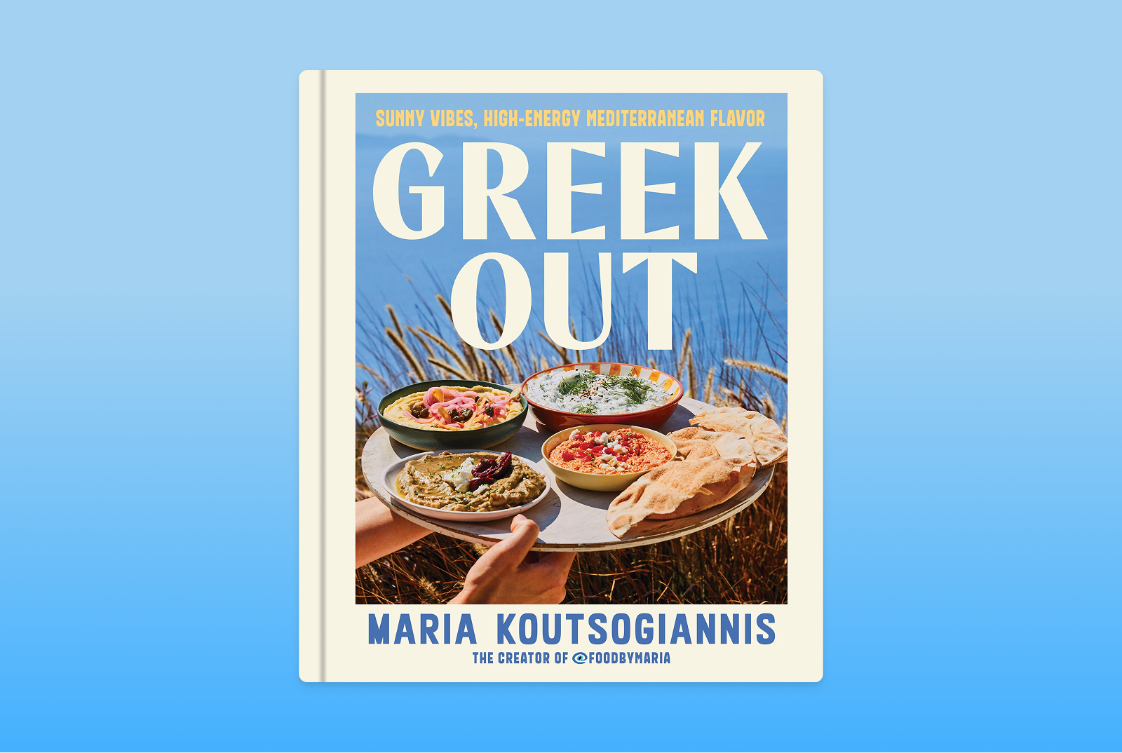 Greek Out cookbook on a blue background