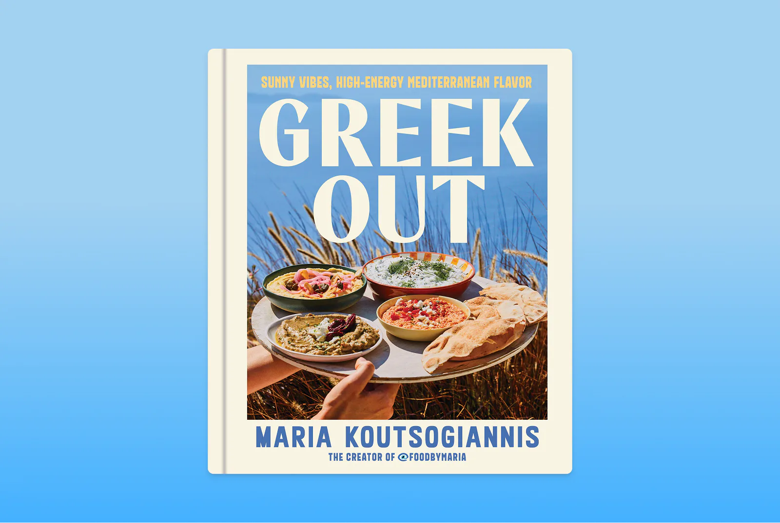 Greek Out cookbook on a blue background